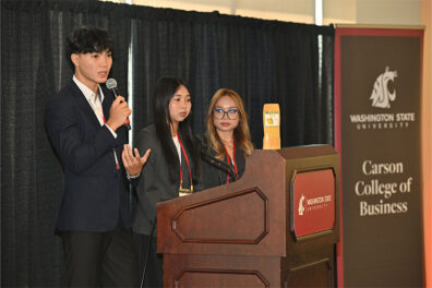 Three CamEd Business School students from team 'Mango Glow' present at the 2025 Marketing and International Business Symposium at Washington State University.
