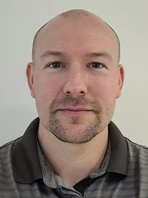 Headshot of Ash Hyman.