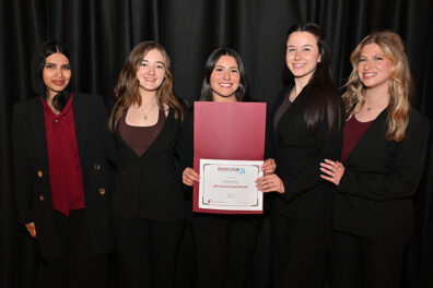 Meat & Potatoes team members pose with their fifth-place award certificate at the Business Plan Competition.