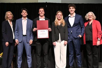 RECOVR team members pose with their fourth-place award certificate at the Business Plan Competition.