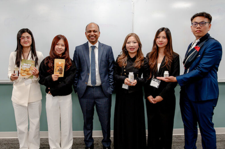 CamEd Business School students pose with product samples during a venture presentation and exchange with WSU students.