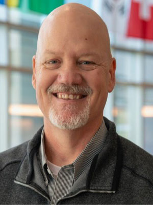 Headshot of Mark Shuster.