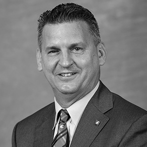 Grayscale headshot of Kyle Smith.