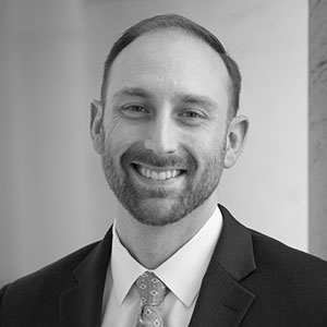 Grayscale headshot of Nick Streuli.