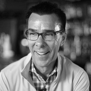 Grayscale headshot of Tony Rojas.