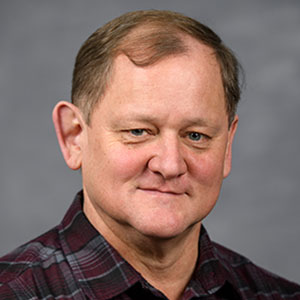 Headshot of Gregory Denton.