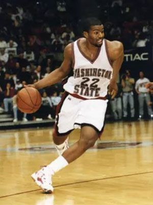 Isaac Fontaine dribbling a basketball in a Washington State jersey with number 22 during a game.