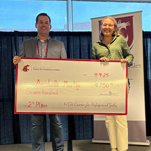 Annabelle Jewell and another individual holding a $750 check for 2nd place from the WSU Center for Professional Sales.