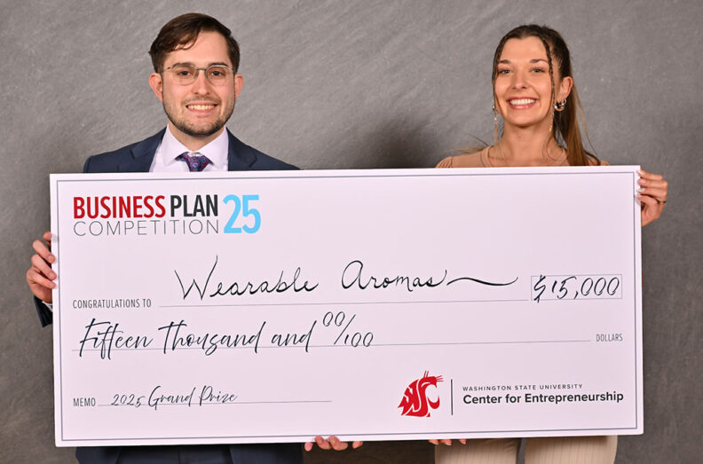 2025 BPC Winning team Wearable Aromas holding large check representing $15,000 winning prize