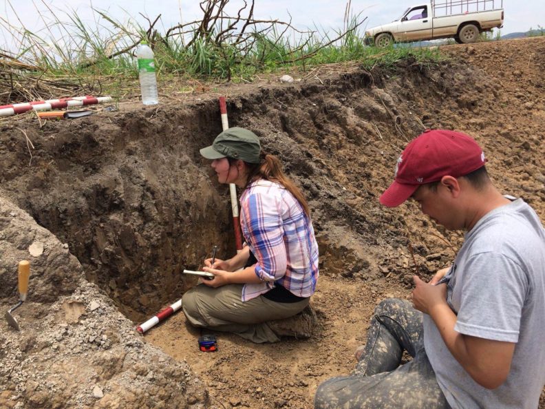 Students looking at layers of soil.