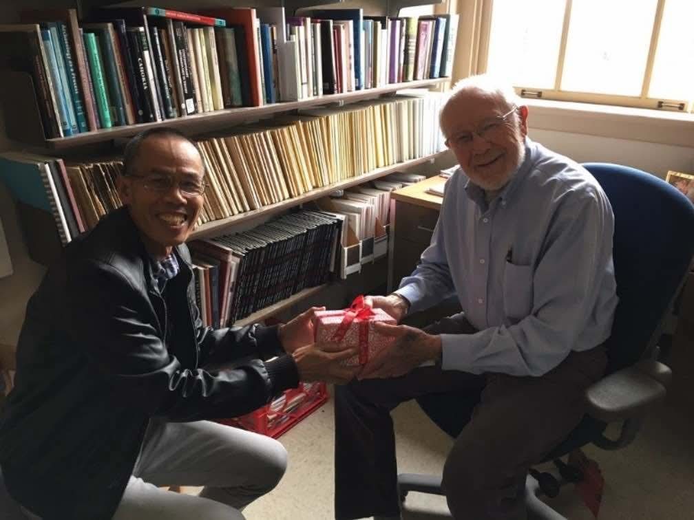 Bill with former student Sawang Lertrit holding a gift in his office.