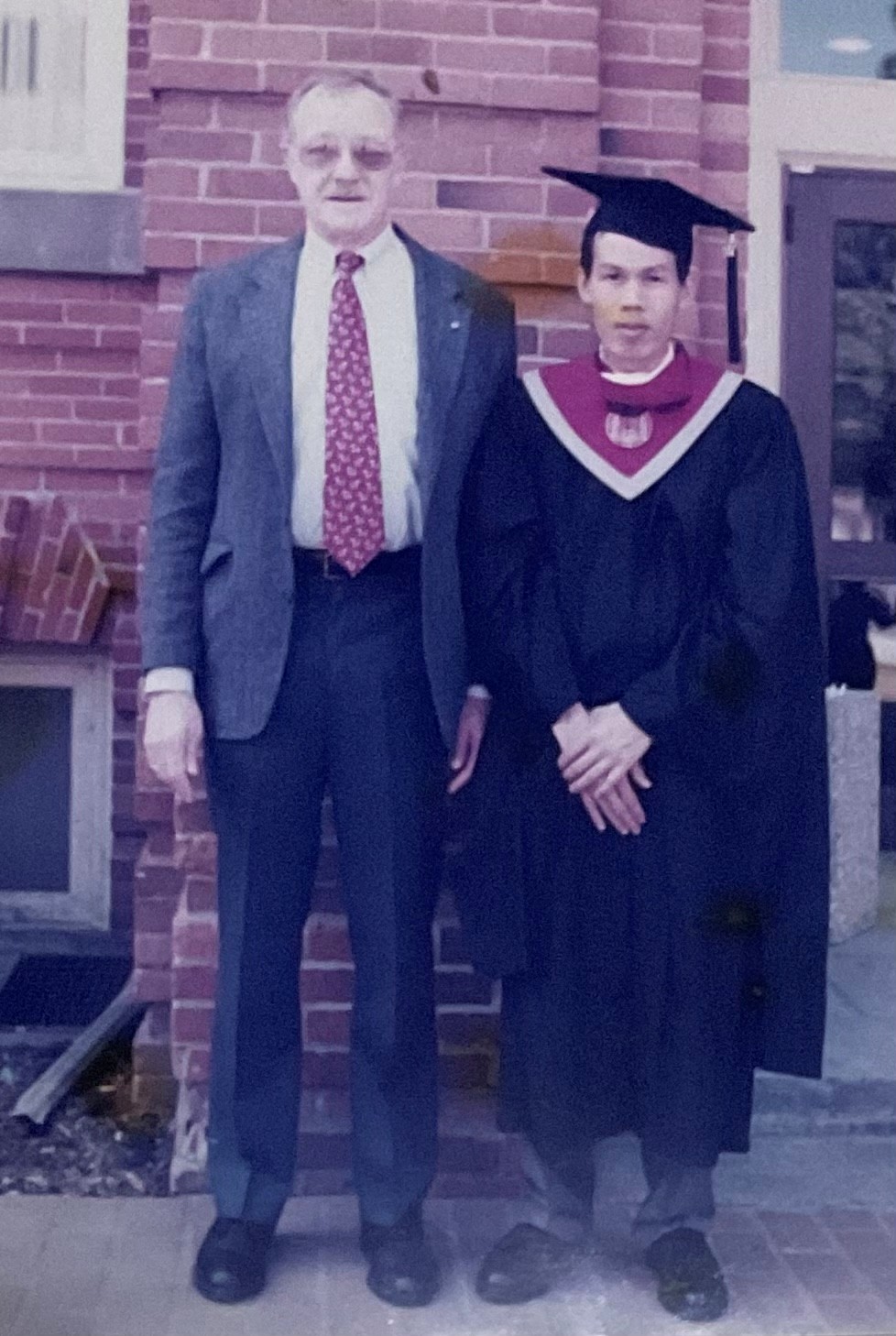 Bill with student wearing cap and gown