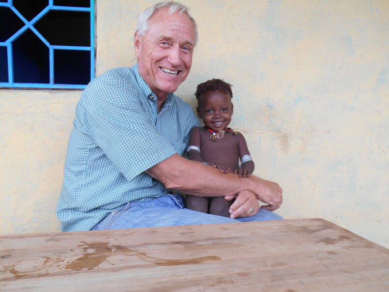 Barry Hewlett holding baby