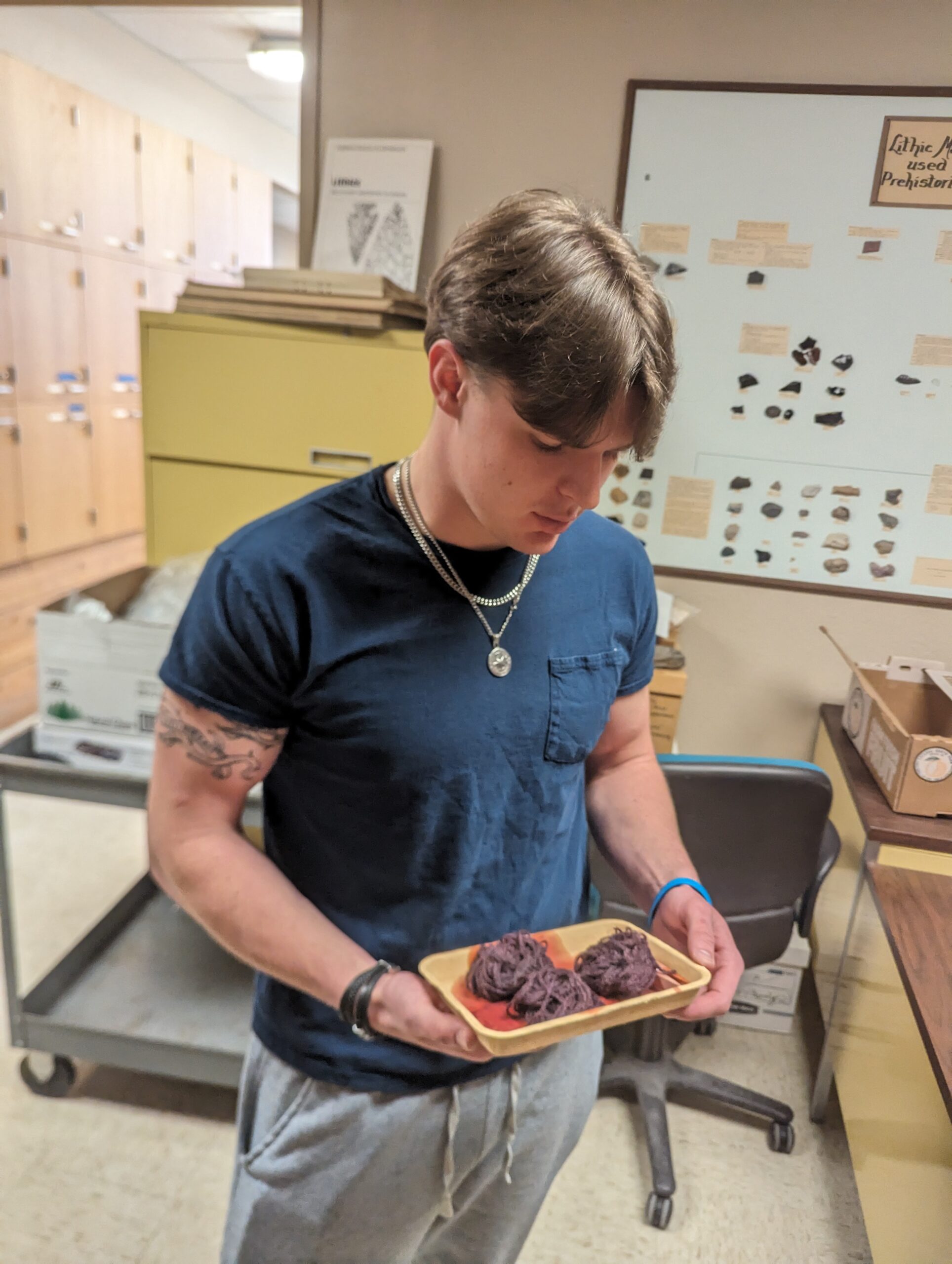ANTH 340 student holding dyed yarn