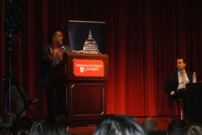 Dr. Willits looks on as Dr. Boyd addresses the audience.