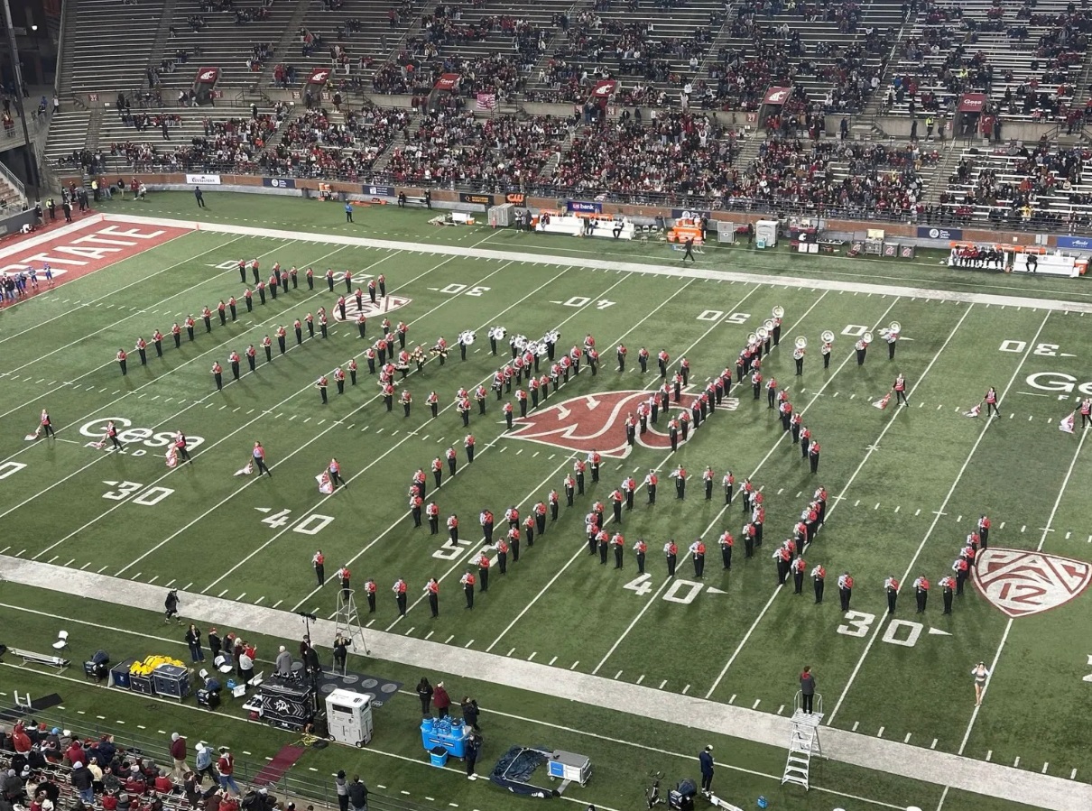 WSU Cougar Marching Band spelling out text, Thank you, on the field at a game