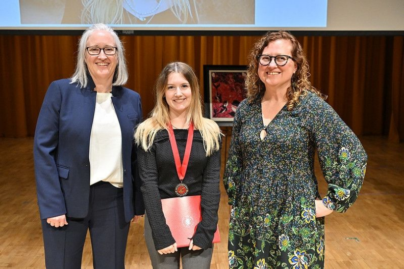 Asterion Bork (center) receives the Outstanding Senior Award from Interim Dean Courtney Meehan (left) and Associate Dean Catherine Cooper (right).