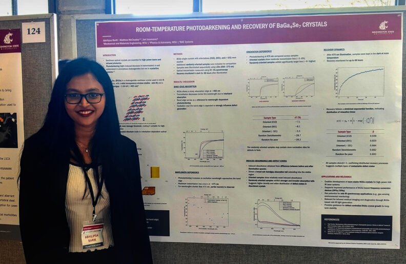 PhD candidate Abhilipsa Barik stands in front of her research poster.