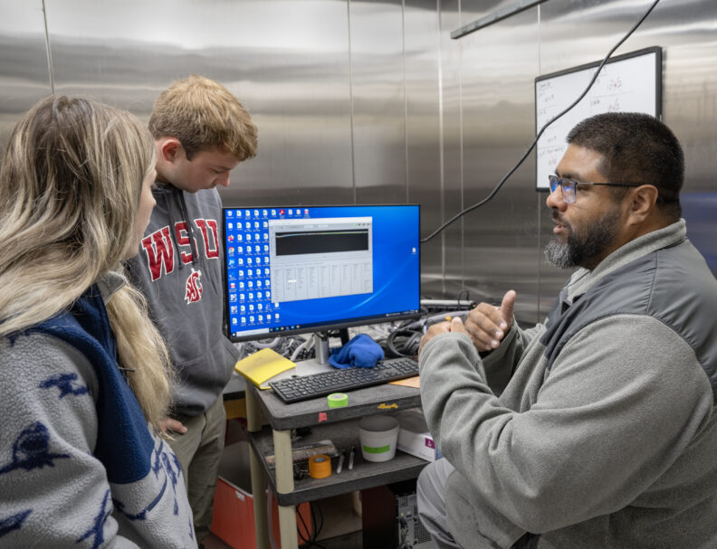 Undergrad students work with a Graduate student conduction a respirometry trial with juvenile chinook salmon in Professor Paul Wheeler’s Fish Lab in Professor Paul Wheeler’s Fish Lab on the campus of Washington State University, Tuesday, June, 6, 2023.