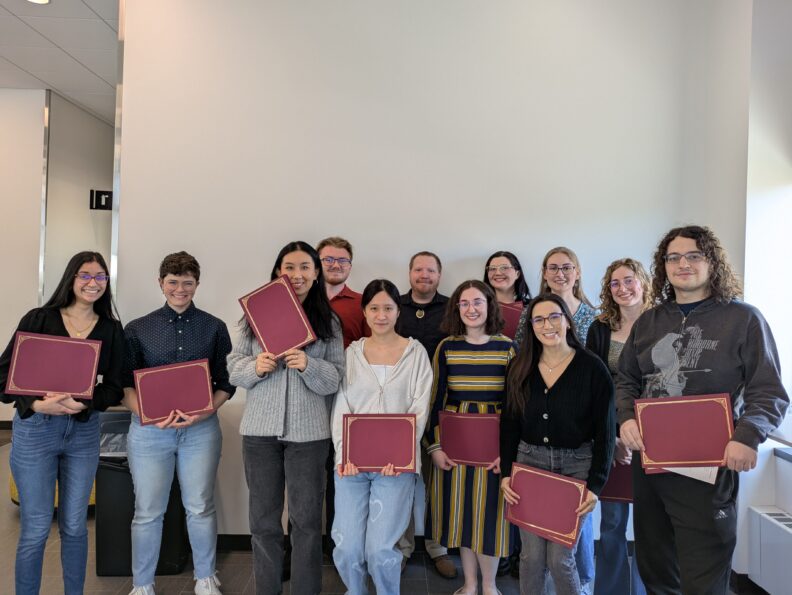 Graduate students pose with their awards
