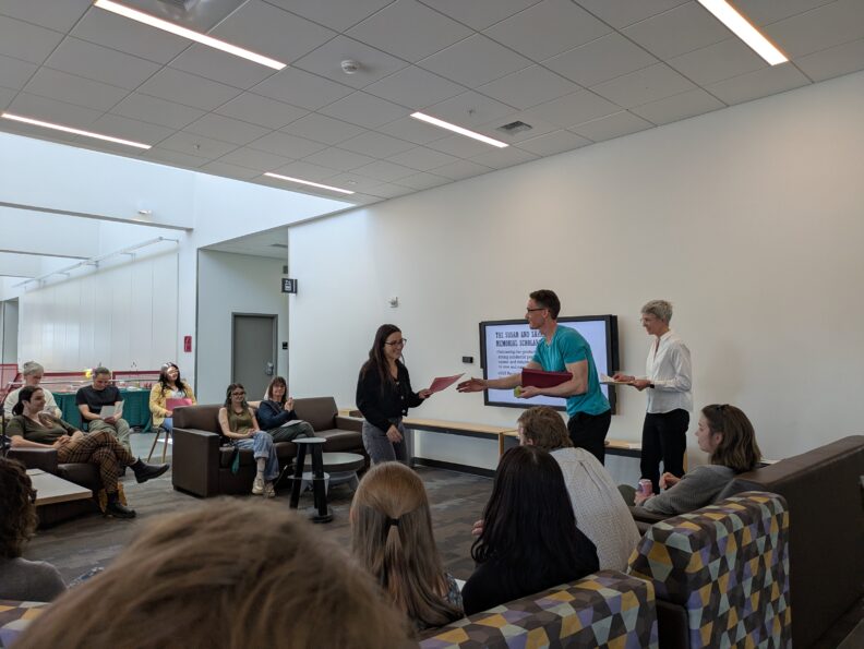 Graduate student accepting award at award ceremony