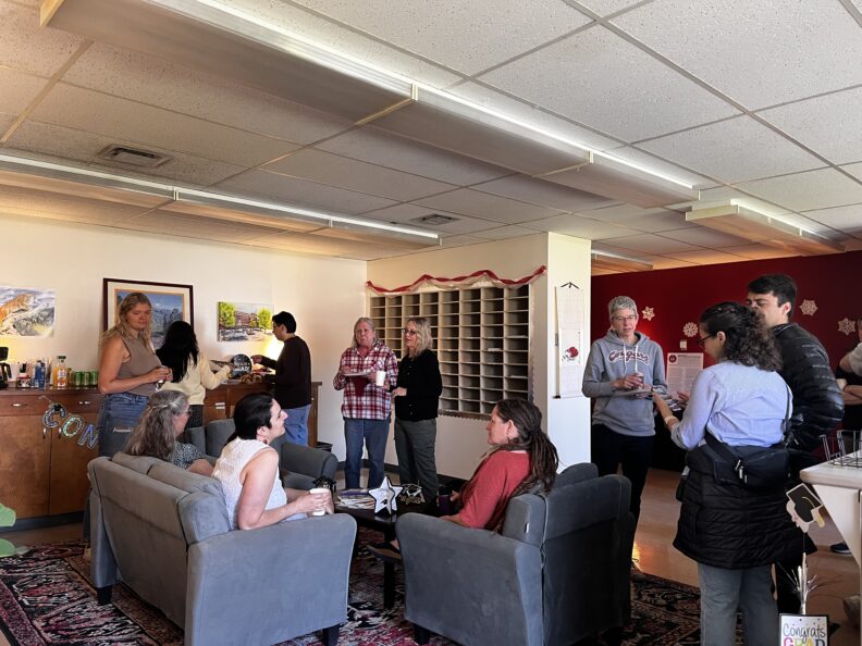 an image of faculty and students mingling at the sociology graduate party