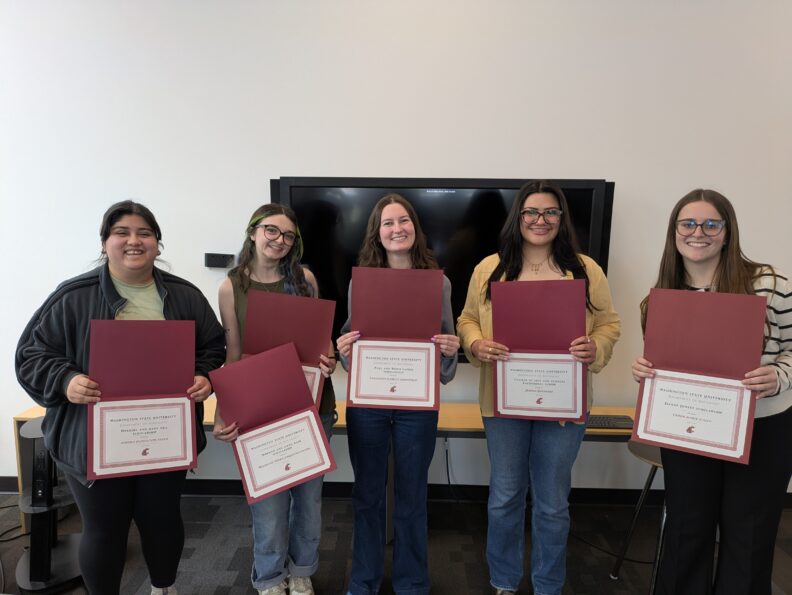 Undergraduate students posing with their awards