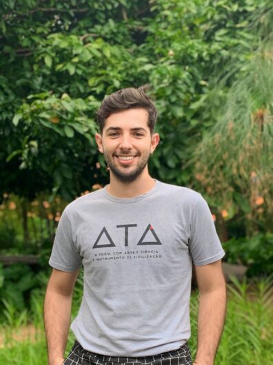 A photo of Joao Augusto Rodrigues in front of greenery