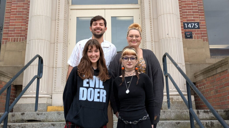 Renate Fort, Michaela Mcparland, Joao Augusto Rodrigues, and Paisley Smith stand in front of Wilson-Short Hall.