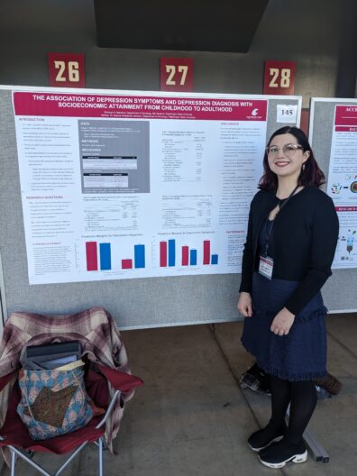 Bronwyn Valentine standing next to her research poster
