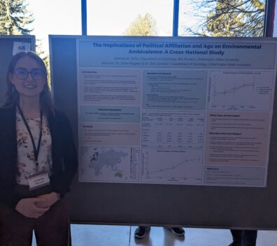Jasmine Willis standing next to her research poster