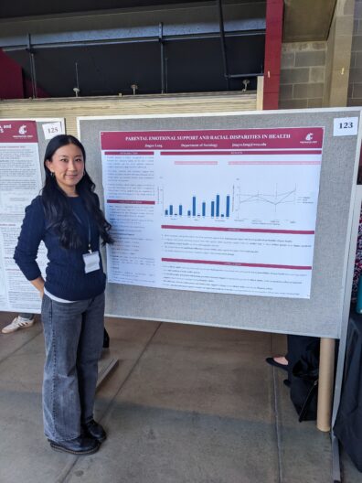 Jingyu Lang standing next to her research poster