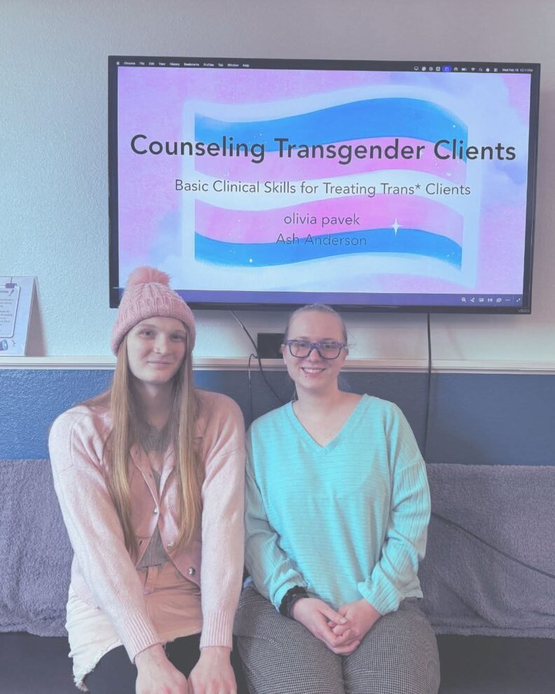 a photo of two people presenting on counseling transgender clients
