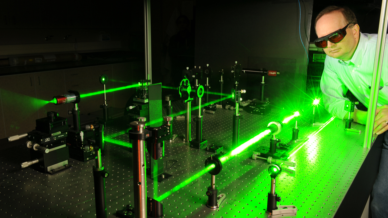 person working with laser