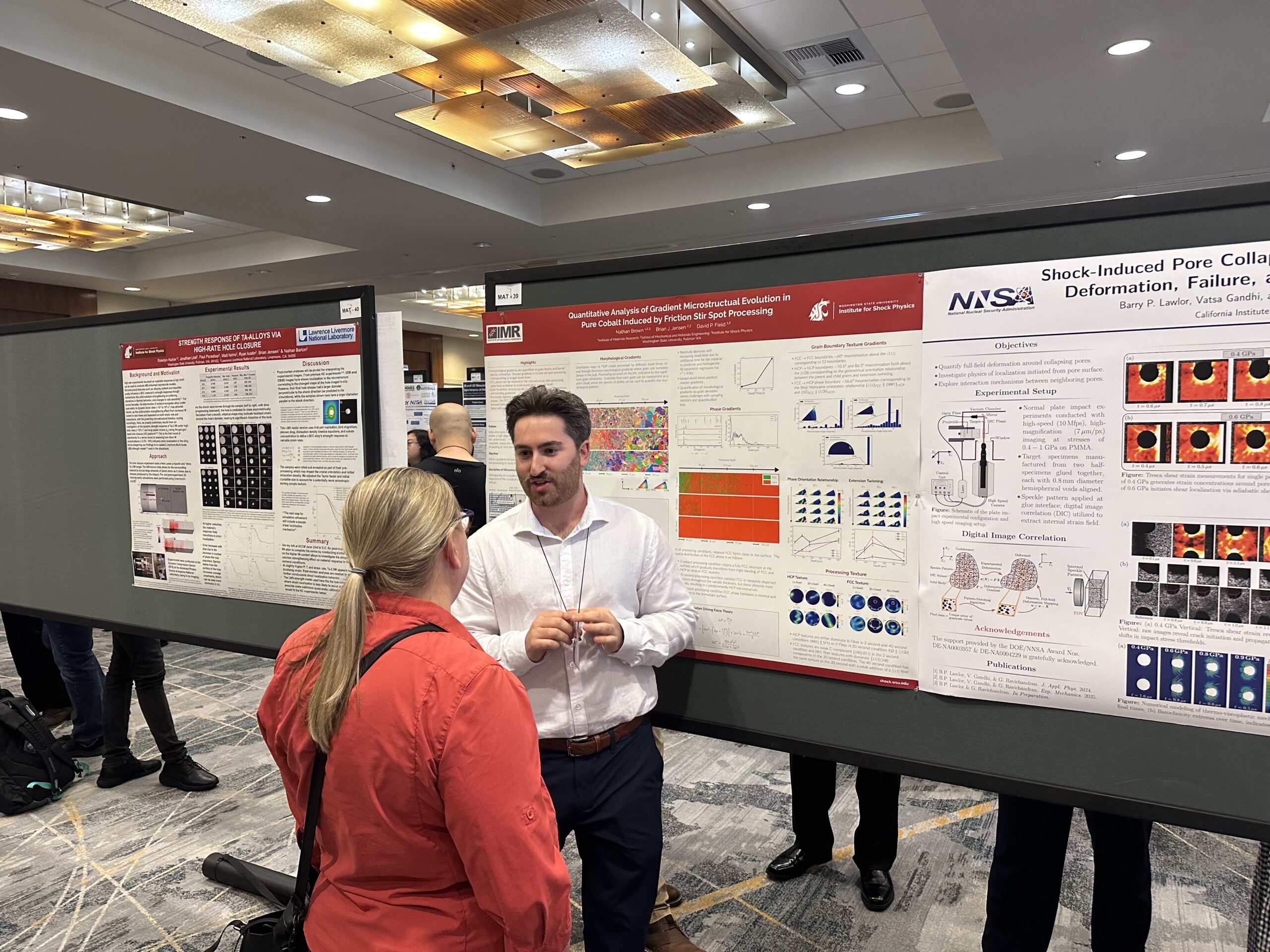 WSU student presenting research at a conference poster event.