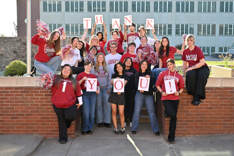 College of Arts and Sciences ambassadors holding cards to spell out "Thank You!"