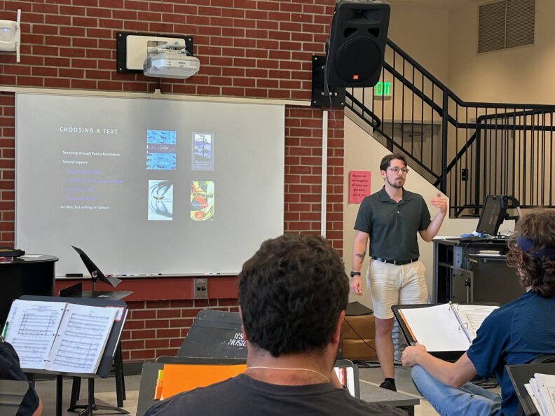 Jacob Malpocker speaking in front of a group.