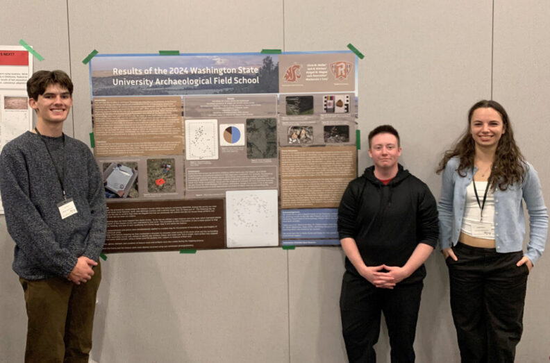 Three WSU students stand next to a poster at an archeology conference.