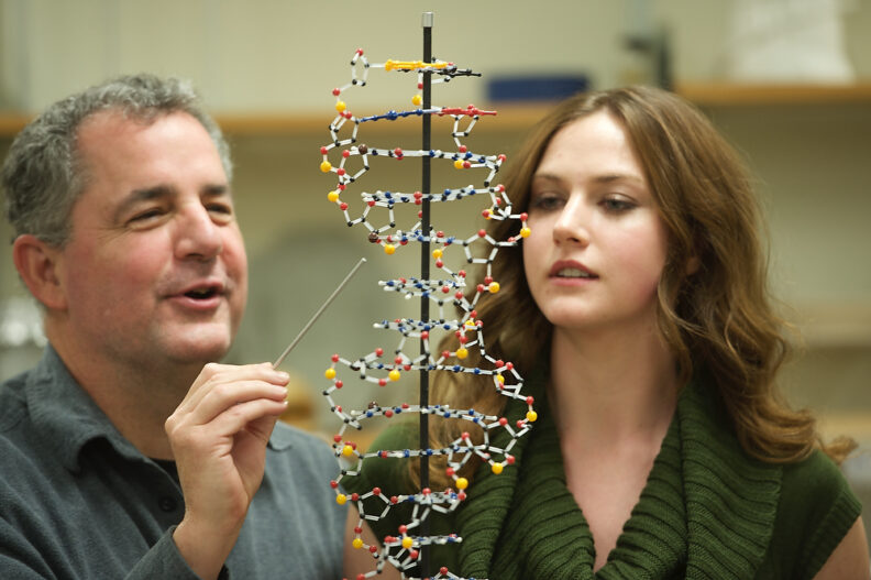 Professor Patrick Carter working with a student.