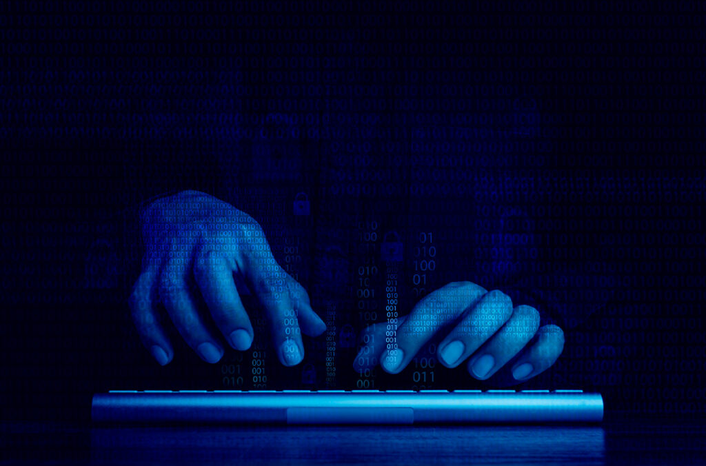 A composite featuring a darkly lit pair of hands typing on a keyboard and several lines of computer code.