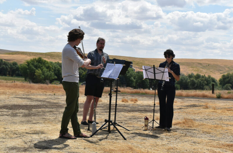 Alex Crisp, Kamil Tarnawczyk, and Calby Van Hollebeke perform on the Miller family farm in LaCrosse as part of the “Harvest Interludes” project.