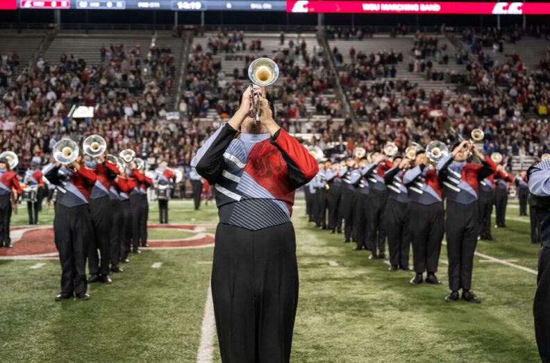 Members of the WSU Marching Band perform at half time of a WSU football game.