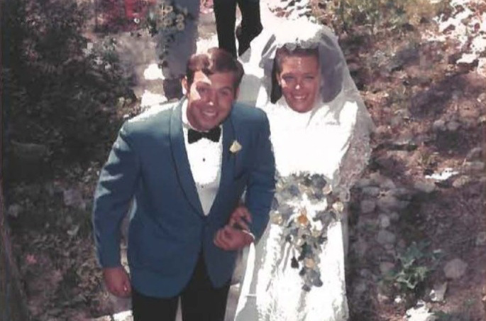 Gary and Mimi on their wedding day in bridal attire.