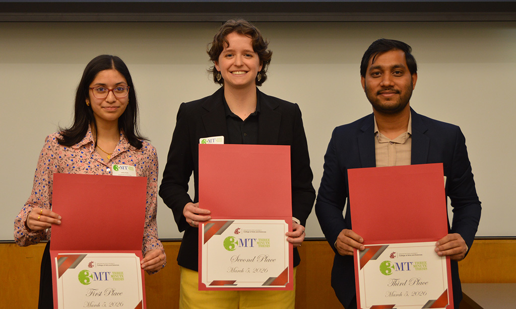 Three students holding their award certificates.