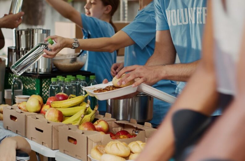 Volunteers serving meals at a food bank.