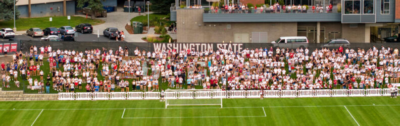 An aerial view of fans alongside a WSU soccer field.