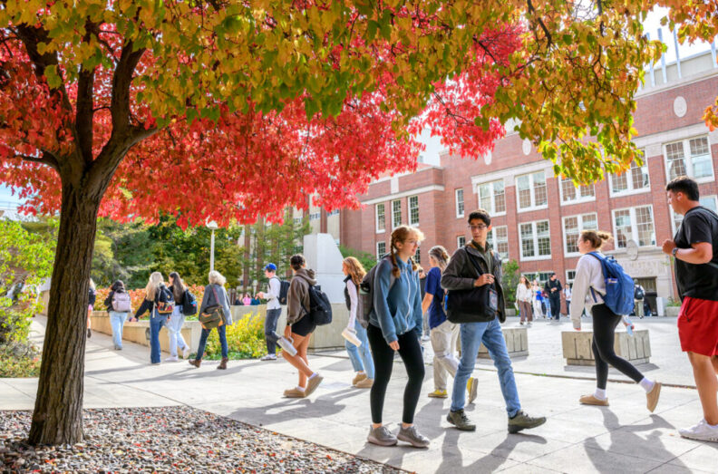Students walking on sidewalks of the WSU Pullman campus between classes.