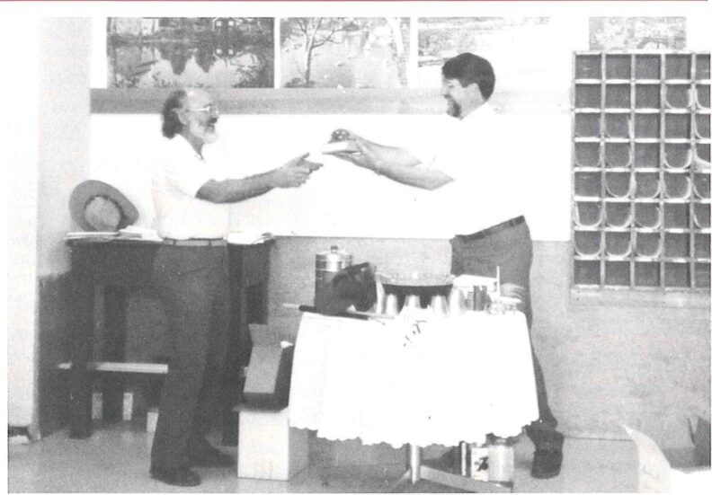 Former chair Royston Filby & new chair Roger Willett exchange gifts in 1992