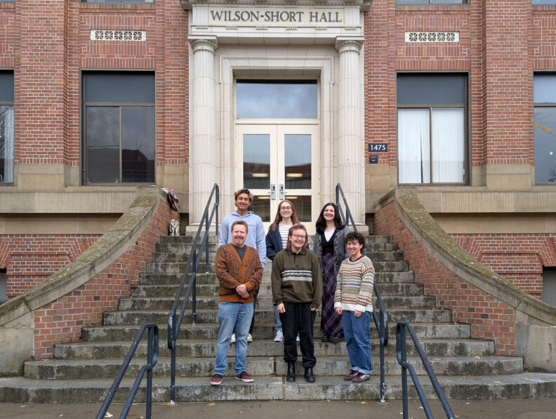 Sociology graduate students standing on the steps of Wilson-Short Hall.