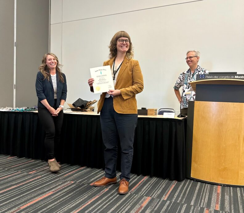 Shervey holding the award for the competition.